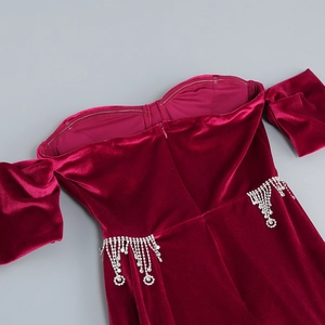 Detail of off-shoulder neckline and velvet dress with sparkling rhinestone fringes
