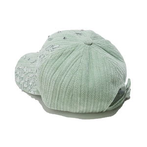 Detail of mint green velvet baseball cap with sparkling crystal rhinestones and metal buckle
