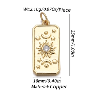 Detailed view of a gold rectangular pendant with sun, moon, star relief and zircon