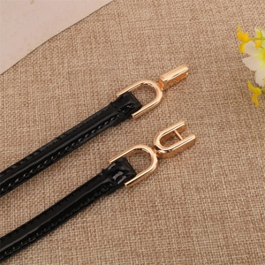 Minimalist black patent leather skinny belt with elegant gold U-shaped metal buckle for women