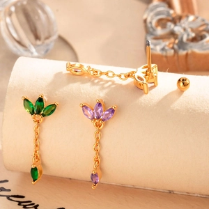 Three-piece gold ear stud set with colorful zircon tassels and leaf design on beige roll
