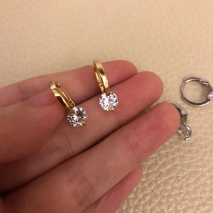 Detailed view of S925 sterling silver hoop earrings with round zircon stones in gold and silver