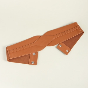 Detail of brown wide elastic waist belt with faux leather front and metal snap buttons