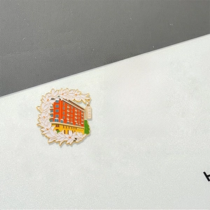 Detail of colorful Shanghai enamel badges featuring the Bund skyline and Wukang Mansion
