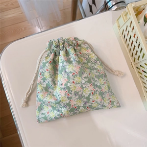 Detail of oil painting floral drawstring pouch with mint green cotton fabric and cotton rope