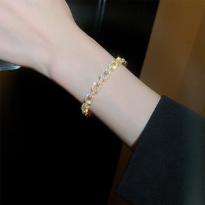 Close-up of gold plated chain bracelet with sparkling cubic zirconia on a wrist