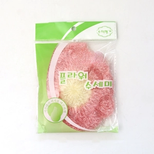 Macro detail of a flower-shaped acrylic knit dish scrubber in pink and beige retail bag
