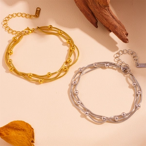 Detailed close-up of tricolor stainless steel snake chain bracelets with beads