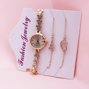 Detailed view of women's rose gold quartz watch set with decorative heart bracelets