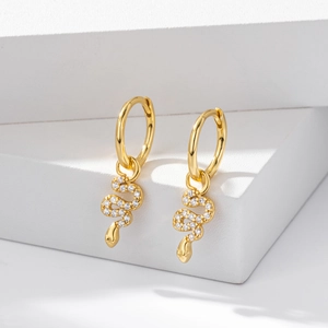 Elegant gold S925 sterling silver snake earrings with pavé zircon stones on white background