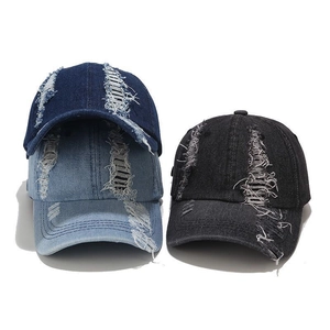 Distressed denim baseball caps with vintage ripped details in blue and black colors