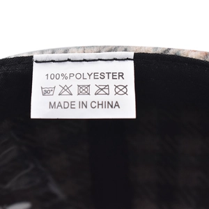 Detailed view of 100% polyester houndstooth baseball cap interior label and stitching
