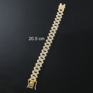 Macro detail of 20.5 cm iced-out gold Cuban link bracelet with sparkling rhinestones