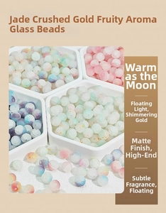 Close-up of 8mm frosted glass beads with gold flakes in a white hexagonal tray