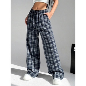 Detail of high-waisted plaid wide-leg trousers with elastic drawstring and side pockets