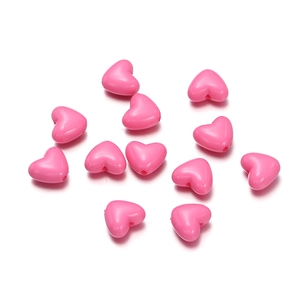 Detailed top view of pink heart-shaped acrylic beads for DIY jewelry and crafts