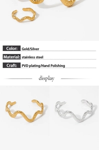 Detail view of wavy stainless steel rings showing PVD plating and hand polished finish