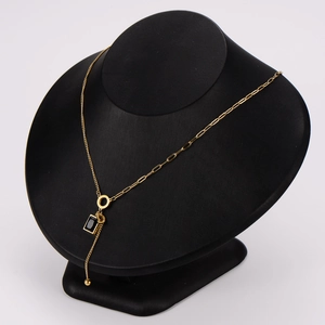 Elegant gold choker necklace with black acrylic charms and metallic tassel accents