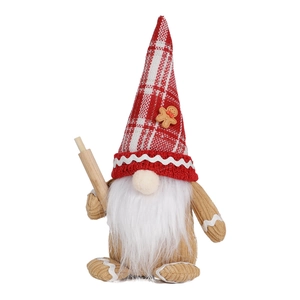Close-up of a Christmas gnome with a red plaid hat, gingerbread decor, and wooden pin