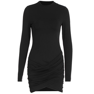 Close-up of cross-overlap pleated hem on a black long sleeve bodycon mini dress