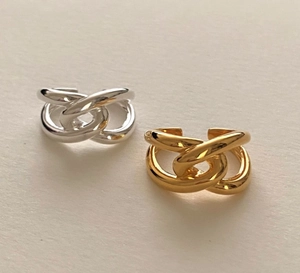 Detail of silver and gold interlaced hollow rings with adjustable open band design