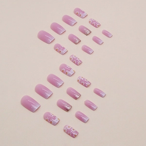 Pink gradient press-on nails set with white daisy patterns and silver glitter accents