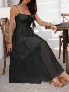Close-up of black high-waisted tiered maxi dress with ruffles for summer vacation