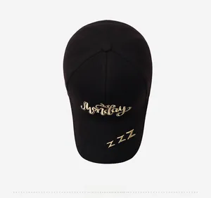 Detailed close-up of Monday embroidery on a black cotton baseball cap top view