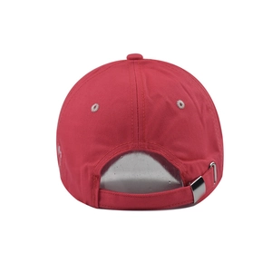 Detail of red cotton baseball cap back with adjustable fabric strap and silver metal buckle
