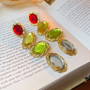 Vintage style oval gemstone earrings with twisted gold metal frames in four colors