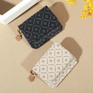 Detail of crossbody card wallets in black and beige with Madley monogram and gold hardware