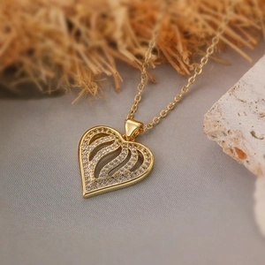 Hollow heart pendant necklace in gold finish with sparkling cubic zirconia inlay