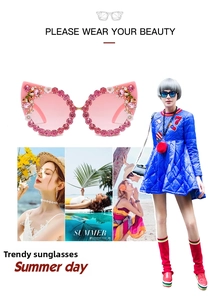 Pink cat-eye sunglasses with detailed crystal embellishments and small white flower accents