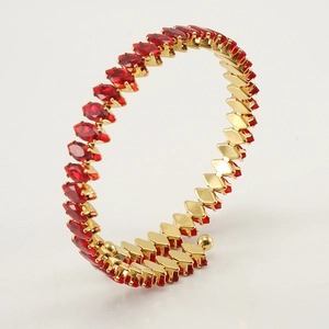 Detail of 18K gold plated open bangle with red marquise cubic zirconia gemstones