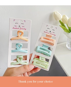 Macro detail of matte macaron resin hair clips in twisted and hollow rectangular shapes