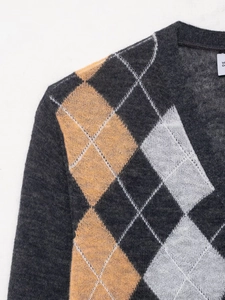 Detailed view of the diamond argyle knit pattern and fine texture on this cropped sweater