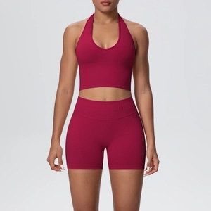 Detail of red halter neck sports bra and high-waisted ribbed shorts fitness set