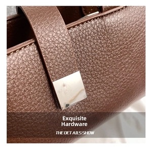 Macro detail of brown pebble grain leather handbag with silver square metal hardware