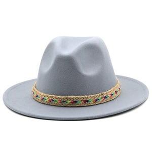 Detail of grey wool felt fedora hat featuring a colorful tribal style woven decorative band