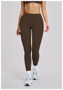 Detail of high-waisted dark brown yoga pants with matte fabric and body-hugging fit