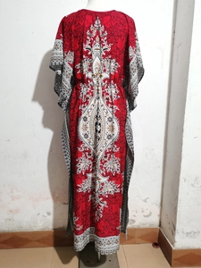 Detailed close-up of bohemian red floral pattern on lightweight beach kaftan cover-up