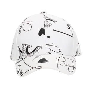Detailed view of white cotton baseball cap featuring black Paris Eiffel Tower graffiti