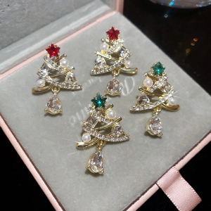 Macro detail of Christmas tree earrings with pearls, crystals, and teardrop zircons