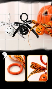 Detail view of Halloween pumpkin bell keychains with metal ring and festive ribbons