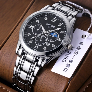 Men's silver stainless steel watch with black dial and luminous hands on a wooden base