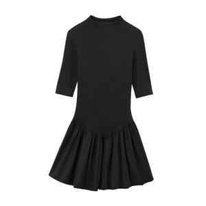 Black mock neck dress with knitted top and pleated patchwork skirt shown on white background