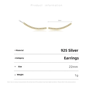 Macro shot of 925 silver curved earrings with gold plating and paved zircon stones