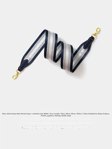Detail showing 5cm wide blue and silver striped woven shoulder strap with gold hooks
