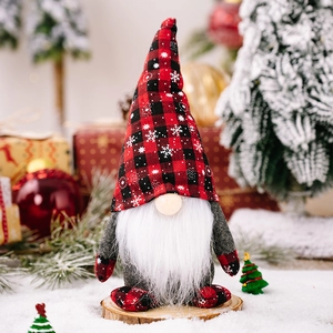Detailed view of Christmas gnome with red plaid snowflake hat and white beard