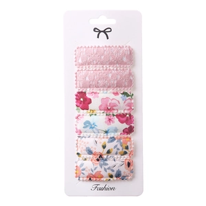 Detail of 6-piece square floral embroidery and pink lace fabric BB hair clips on display card